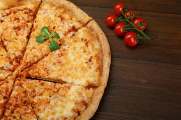 cheese pizza on dark wooden background top view.