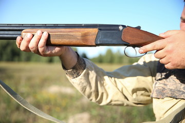 hunter aiming with hunting rifle close up.