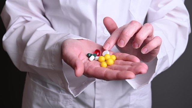 Female doctor holds in hands tablets, vitamins. Treatment of people with covid19