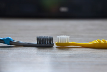 pair soft toothbrushs on the wood table