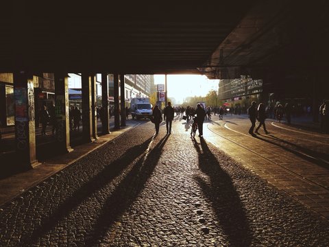 People Walking Under Bridge