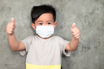 A boy wearing medical face mask for pollution or coronavirus,child itchy eyes and nose, Kid scratching nose while wearing protection mask.Protection against contagious disease, coronavirus.