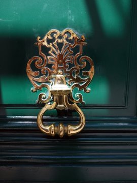 Gold Color Doorknob On Green Door