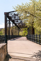 An old railroad bridge converted into a walking trail on a sunny spring day in Pittsburgh, Pennsylvania, USA