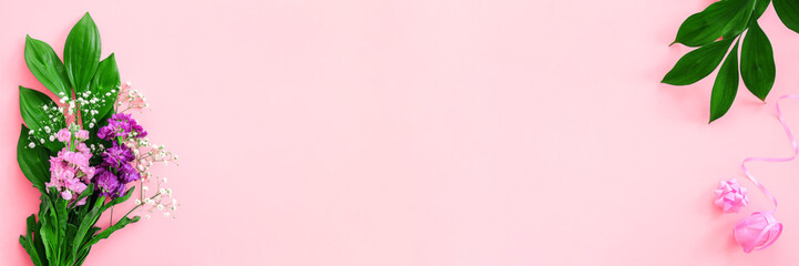 Floral border. Bouquet flowers and bow, ribbon on pink background. Greeting card Flat Lay Copy space Concept Hello summer, Mother's day, Womens day, Good day Template Banner