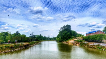 Fototapeta na wymiar View Of River Against Cloudy Sky