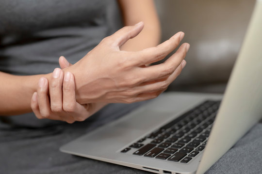 Woman with pain in her hand because of hard work, Ache in human body , office syndrome,Bone and joint disease, Concept healthcare and medical.
