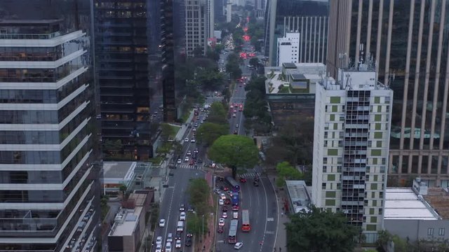Faria Lima avenue aerial view with camera passing by close to buildings, intense traffic and cloudy day. São Paulo, Brazil