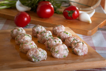 Raw homemade meatballs with minced meat with herbs
