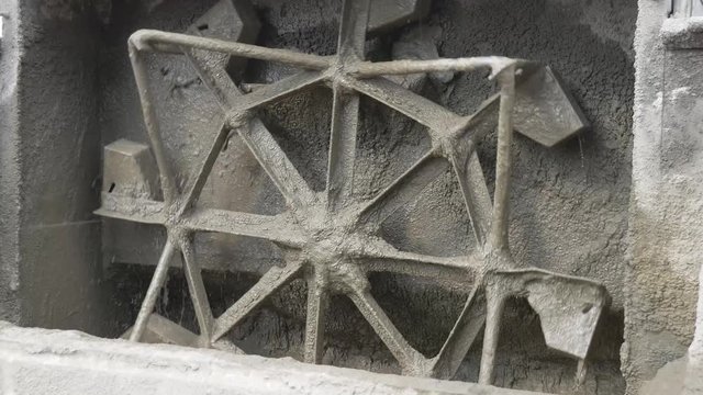 Close-up of a concrete mixer, mixing cement mortar. Concrete mixer.