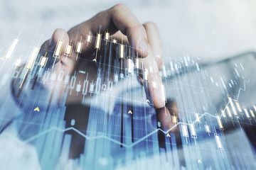 Abstract creative financial graph with finger clicks on a digital tablet on background, financial and trading concept. Multiexposure