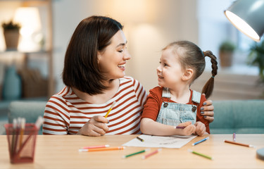 Mother and daughter are painting together