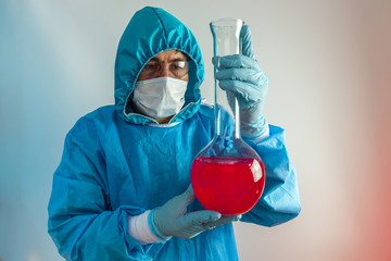 Scientist reviews a flask with a chemical formula, vaccine