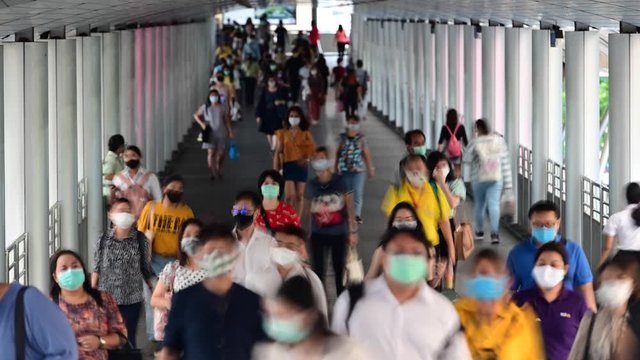 4K Time lapse of crowded asian people wear face mask walking on rush hour