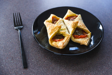 plant-based food, vegan tomato pastry with pesto and olives