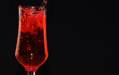 carbonated drink is poured into a glass