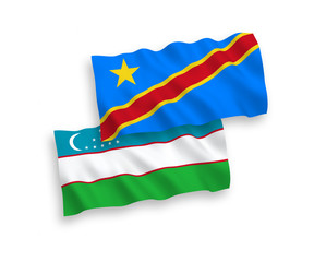 Obraz premium National vector fabric wave flags of Uzbekistan and Democratic Republic of the Congo isolated on white background. 1 to 2 proportion.