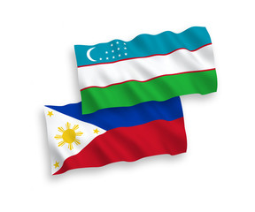 National vector fabric wave flags of Uzbekistan and Philippines isolated on white background. 1 to 2 proportion.