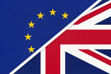 Fototapeta na wymiar European Union or EU vs United Kingdom or UK national flag from textile. Symbol of the Council of Europe association.