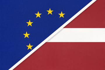 European Union or EU vs Latvia national flag from textile. Symbol of the Council of Europe association.
