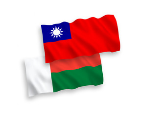 National vector fabric wave flags of Madagascar and Taiwan isolated on white background. 1 to 2 proportion.