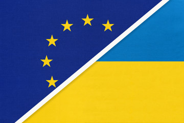 European Union or EU vs Ukraine national flag from textile. Symbol of the Council of Europe association.