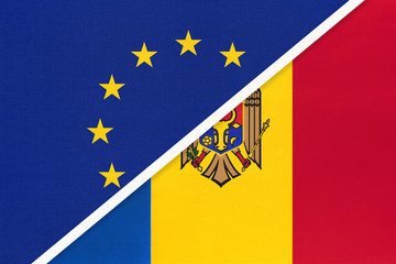 European Union or EU vs Moldova national flag from textile. Symbol of the Council of Europe association.