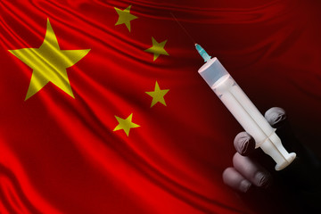 Syringe on the background of the Chinese flag. The development of a vaccine against the...