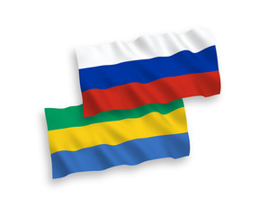 National vector fabric wave flags of Gabon and Russia isolated on white background. 1 to 2 proportion.