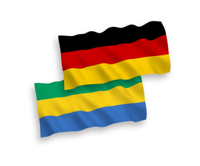 National vector fabric wave flags of Germany and Gabon isolated on white background. 1 to 2 proportion.