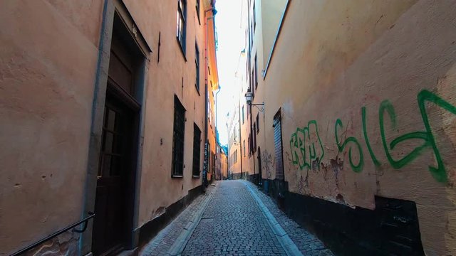 First Person POV Walking Down Narrow Alley Past Graffiti. Gamla Stan, Stockholm.