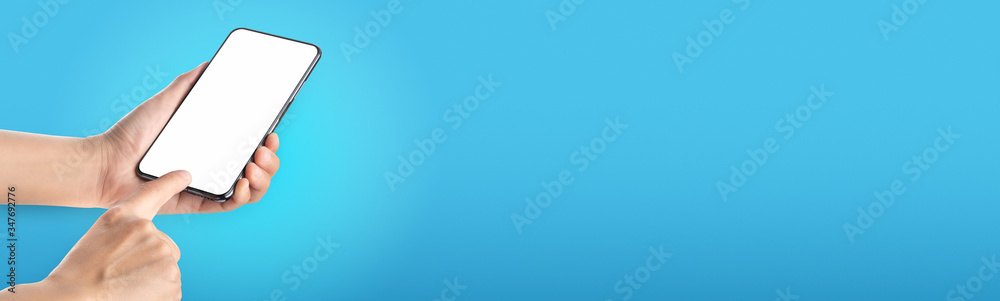 Poster mockup hand touch on mobile blank screen on blue background in banner size for display of content to advertise on online media.technology background..clipping path on both hand and phone screen