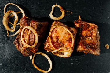 marinated meat cutted on pieces and ready for shashlik or kebab on black background