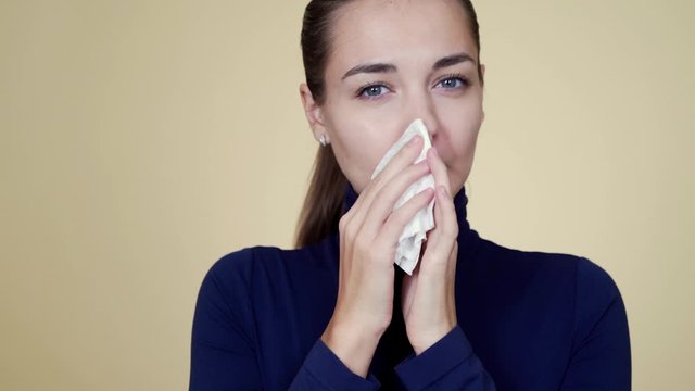 Portrait of woman feeling bad, blows nose in napkin, coughs, isolated on background