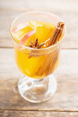 Healthy hot beverage with oranges, apples and spices for protection in flu season. Selective focus. Shallow depth of field.