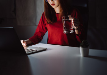 Korean woman working late time with laptop computer drinking water home office workhard overworked, Freelancer stay home business quarantine sleepless crisis coronavirus stay home dark room...