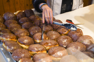 A lot of small round deep fried donuts, simple, no syrup or dipping sauce. Large bowl of donuts