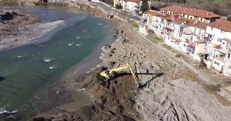 Aerial Water escavators working together on Arno river near Sieci town, Pontassieve, to avoid another Florence disaster flood after latest November rainy long season. Sunny day Winter, Tuscany. Italy