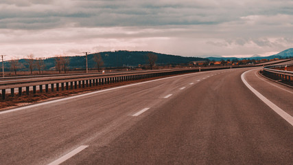 Empty track outside city with fields and road marking