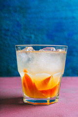 Old fashioned beverage with orange slices on rustic background. Selective focus. Shallow depth of field.
