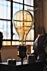 Fotobehang Milan, Italy, 2017.05.21 evocative image of large electric light bulb at a vintage market © massimo