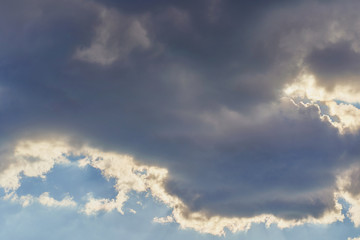 Beautiful blue sky with a cloud and rays of the sun