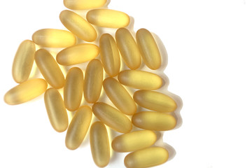 Yellow pills or vitamins on the white background. Healthy life style. Pandemic concept.
