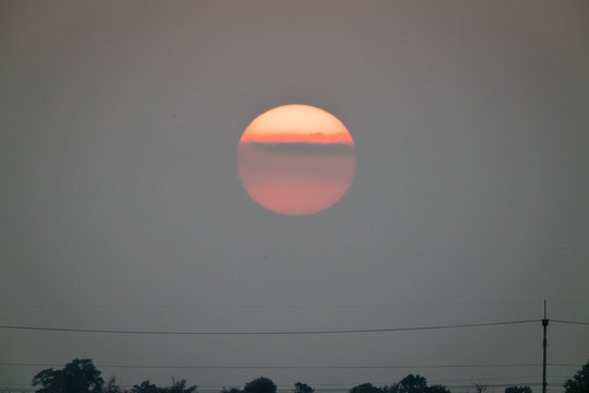 Big Sun Set With Cloud And Grey Sky