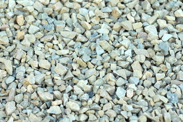 Background of blue and gray gravel. Small stones lie on the ground at a construction site. Pebble pattern on the beach.