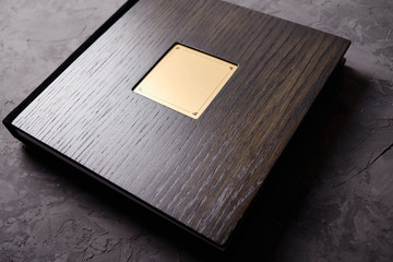 Wood brown wedding photobook on dark concrete background, copy space. Mockup template