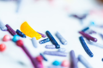 Decorative powder in the form of sweet sticks in the glaze close-up, macro shot.