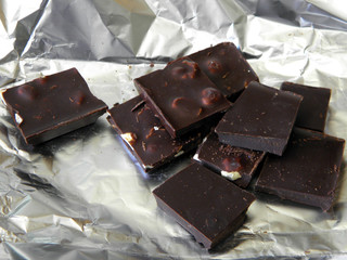 Dark natural Chocolate lies on the foil