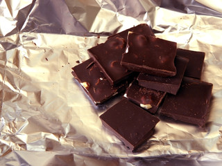 Dark natural Chocolate lies on the foil