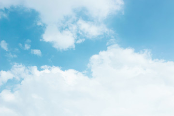 soft white clouds against blue sky background.